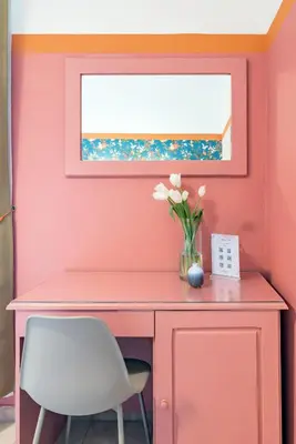 a pink desk with a vase of flowers and a window at Hotel Espana - Gruppo BLAM HOTELS in Rome