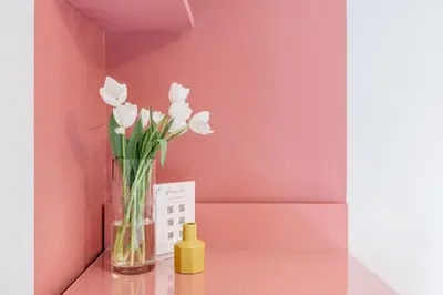 a vase of white flowers sitting on a table at Hotel Espana - Gruppo BLAM HOTELS in Rome
