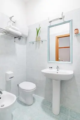 a bathroom with a sink and a toilet and a mirror at Hotel Espana - Gruppo BLAM HOTELS in Rome