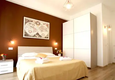 a bedroom with two beds and a painting on the wall at Homs Sweet Home in Rome