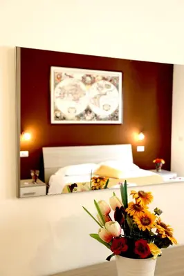 a bedroom with a bed and a vase of flowers at Homs Sweet Home in Rome