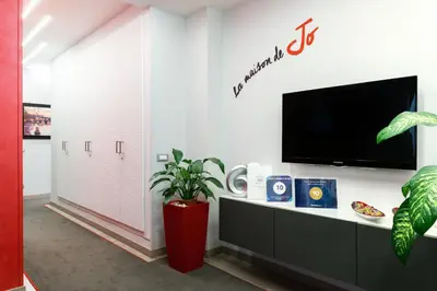 a living room with a tv on a wall at B&B La Maison de Jo in Rome