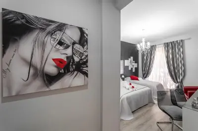a room with a picture of a woman with red lipstick at B&B La Maison de Jo in Rome