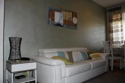 a living room with a white couch and a table at Your Home at Rome in Rome