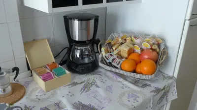 a counter with two baskets of fruit and a blender at Your Home at Rome in Rome
