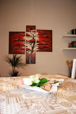 four paintings of a tree on a wall at Your Home at Rome in Rome