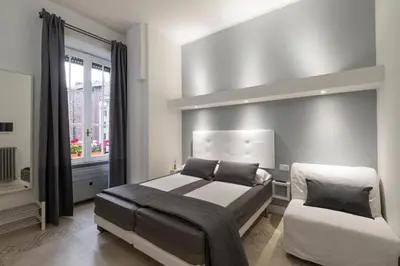a bedroom with a large bed and a window at Vaticanspace Rooms in Rome