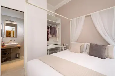 a bedroom with a white bed and a sink at Vaticanspace Rooms in Rome