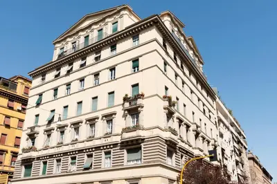 a building with windows and flower boxes on it at Vaticanspace Rooms in Rome