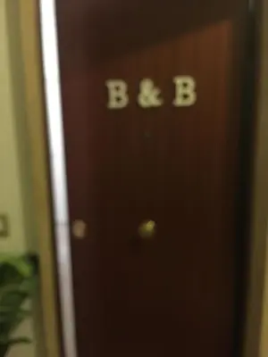 a brown door with the word bee written on it at B&B SPQR in Rome