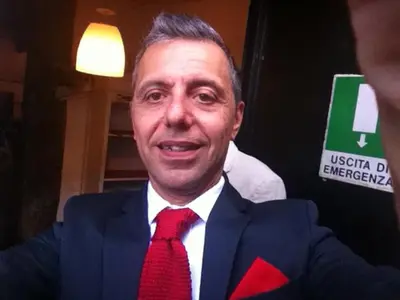 a man wearing a suit and a red tie at B&B SPQR in Rome