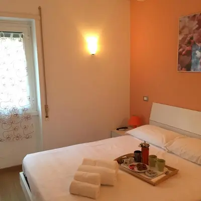 a bedroom with a bed with a tray of towels at B&B SPQR in Rome