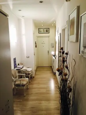 a hallway with chairs and a table and a door at B&B SPQR in Rome
