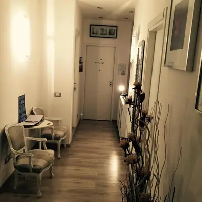 a hallway with chairs and a table and a door at B&B SPQR in Rome