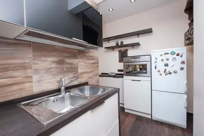 a kitchen with a sink and a refrigerator at Monteverde 2BDR Family Apartment in Rome