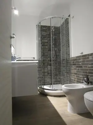 a bathroom with a shower and a toilet and a sink at Pianeta Roma 127 in Rome