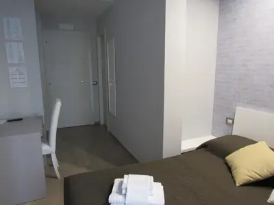 a bedroom with a bed with towels on it at Pianeta Roma 127 in Rome