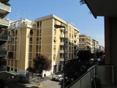 a yellow apartment building in a city at Pianeta Roma 127 in Rome