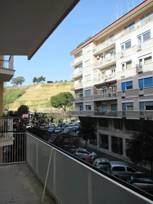 a balcony of a building with a parking lot at Pianeta Roma 127 in Rome