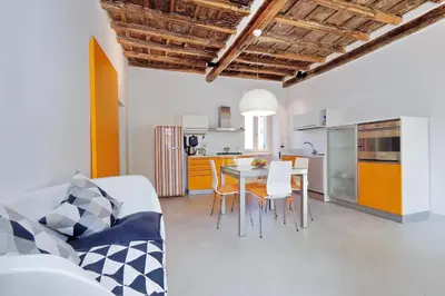 a kitchen and living room with a table and chairs at Reginella in Rome