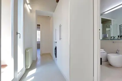 a white bathroom with a sink and a toilet at Reginella in Rome