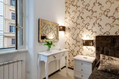 a bedroom with a white table and a mirror at Prime Vatican Suites in Rome