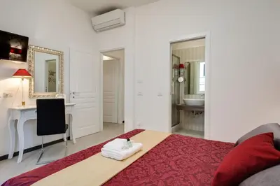 a living room with a bed and a desk in a room at Prime Vatican Suites in Rome