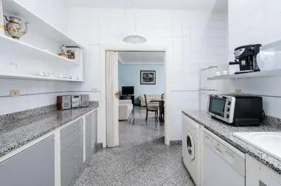a white kitchen with a sink and a microwave at Villa Pamphili Classic Garden in Rome