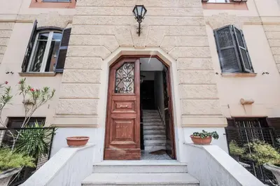 a wooden door on a building with stairs at Villa Pamphili Classic Garden in Rome