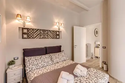 a bedroom with a bed with two towels on it at Vatican Sweet Home in Rome