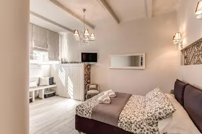 a small bedroom with a bed and a couch at Vatican Sweet Home in Rome