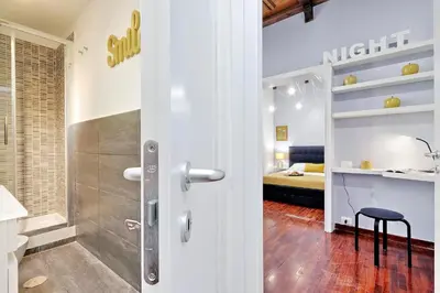 a bathroom with a walk in shower next to a bedroom at Laterano 238 Apartment in Rome