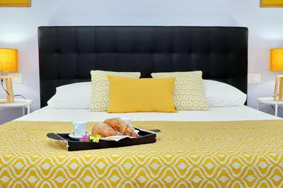 a bed with a tray with a loaf of bread on it at Laterano 238 Apartment in Rome