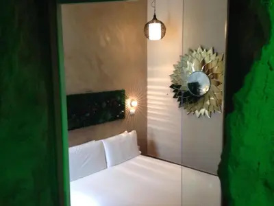a bedroom with a white bed and a mirror at iRooms Central Station in Rome