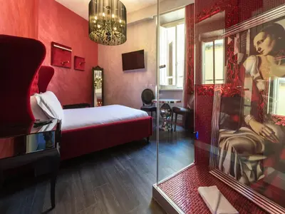 a red room with a bed and a glass wall at iRooms Central Station in Rome