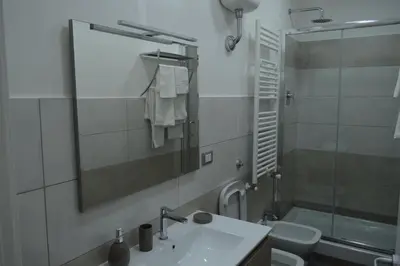 a bathroom with a sink and a shower and a mirror at Bea&B in Rome