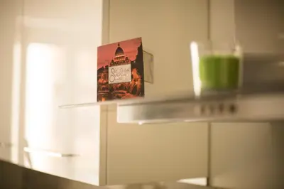 a glass of green liquid sitting on a counter in a kitchen at St. Peter Station Suite in Rome