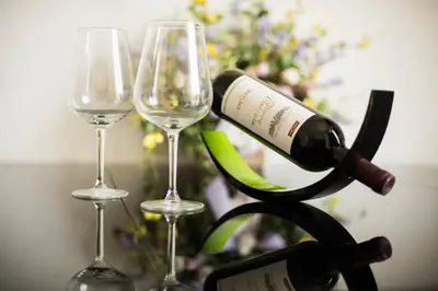 a bottle of wine sitting next to two wine glasses at St. Peter Station Suite in Rome