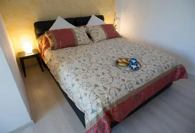 a bedroom with a bed with a plate of food on it at St. Peter Station Suite in Rome