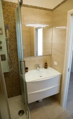 a bathroom with a sink and a mirror at St. Peter Station Suite in Rome