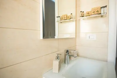 a bathroom with a sink and a mirror at St. Peter Station Suite in Rome