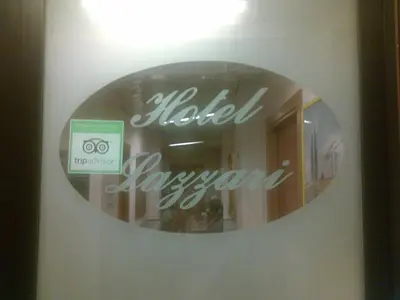 a mirror with a sign in the window of a store at Hotel Lazzari in Rome