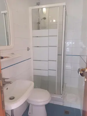 a bathroom with a toilet and a sink and a shower at Hotel Lazzari in Rome