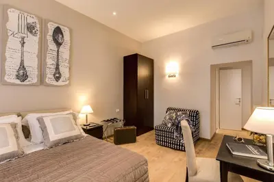 a bedroom with a bed and a desk and a chair at Sweet Stay In Rome in Rome