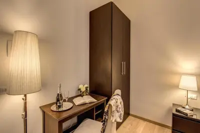 a room with a desk with a lamp and a cabinet at Sweet Stay In Rome in Rome