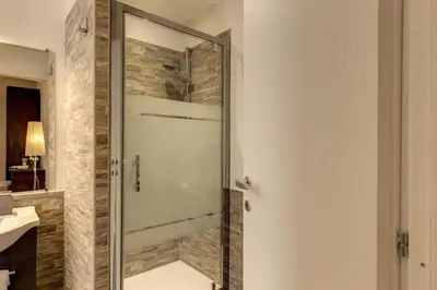 a shower with a glass door in a bathroom at Sweet Stay In Rome in Rome
