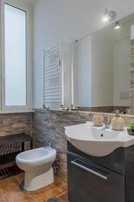 a bathroom with a sink and a toilet and a mirror at Sweet Stay In Rome in Rome