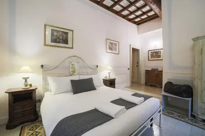 a bedroom with a large white bed with white pillows at La Maison Dell'Orologio in Rome