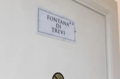 a sign on a wall that reads formicum dtd trap at La Maison Dell'Orologio in Rome