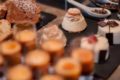 a bunch of different types of desserts on a table at NH Collection Roma Giustiniano in Rome